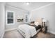 Bright bedroom with a bed, side table, shutters, and hardwood floors at 2083 Amalfi Pl, Apex, NC 27502