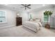 Spacious bedroom with neutral decor, carpet flooring, ceiling fan, and windows allowing natural light at 2083 Amalfi Pl, Apex, NC 27502