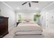 Cozy bedroom with natural light and neutral tones, and a carpet flooring and a view of the en-suite bathroom at 2083 Amalfi Pl, Apex, NC 27502
