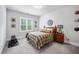 Cozy bedroom with neutral walls, carpeted floor, queen bed, wood nightstand and matching headboard and window with blinds at 2083 Amalfi Pl, Apex, NC 27502
