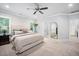 Bright bedroom with neutral decor, plush carpet flooring, and a view of the en-suite bathroom at 2083 Amalfi Pl, Apex, NC 27502
