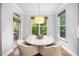 Bright breakfast nook with a marble table, chairs, and natural light at 2083 Amalfi Pl, Apex, NC 27502