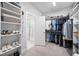 Well-organized walk-in closet with ample storage space, shelving, and a view to the en-suite bathroom at 2083 Amalfi Pl, Apex, NC 27502