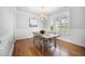 Well-lit dining room with hardwood floors and shuttered windows at 2083 Amalfi Pl, Apex, NC 27502