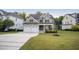 Beautiful two-story house with a three car garage and a well manicured front lawn at 2083 Amalfi Pl, Apex, NC 27502
