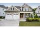 Attractive home with a covered porch, a two-car garage, and manicured landscaping at 2083 Amalfi Pl, Apex, NC 27502