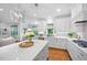 Bright kitchen with stainless steel appliances, white cabinets, and a center island with seating at 2083 Amalfi Pl, Apex, NC 27502
