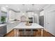 Beautiful kitchen with a large center island, pendant lights, stainless steel appliances, and hardwood flooring at 2083 Amalfi Pl, Apex, NC 27502