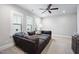 Large living room with several windows, ceiling fan and large sectional couch at 2083 Amalfi Pl, Apex, NC 27502