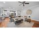 Open-concept living area with a kitchen view, hardwood floors, and comfortable seating at 2083 Amalfi Pl, Apex, NC 27502