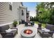 A beautiful patio space with a fire pit, chairs, and a table for outdoor dining at 2083 Amalfi Pl, Apex, NC 27502