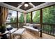 A screened porch is decorated with comfy furniture and a ceiling fan at 2083 Amalfi Pl, Apex, NC 27502