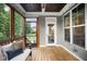 Relaxing screened porch with wooden floors, comfortable seating, and backyard views at 2083 Amalfi Pl, Apex, NC 27502