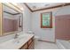 Bathroom with large mirror, vanity, and pink tile bathtub at 221 Jansmith Ln, Raleigh, NC 27615