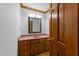 Bathroom with a wood vanity, a granite countertop, framed mirror, and traditional fixtures at 221 Jansmith Ln, Raleigh, NC 27615