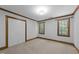 Bedroom with natural light through the windows, neutral carpet and white closet at 221 Jansmith Ln, Raleigh, NC 27615