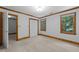 Spacious bedroom featuring natural light, trim detail, closet and neutral carpet at 221 Jansmith Ln, Raleigh, NC 27615