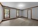 Bedroom with natural light through the windows and neutral colored carpet at 221 Jansmith Ln, Raleigh, NC 27615