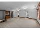 Bright bonus room with built in cabinets and shelving, neutral carpet, and ceiling fan at 221 Jansmith Ln, Raleigh, NC 27615