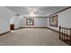 Spacious bonus room features neutral carpeting, windows for natural light, and ceiling fan at 221 Jansmith Ln, Raleigh, NC 27615