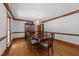 Formal dining room with hardwood floors, crown molding, a chandelier, and a classic china cabinet at 221 Jansmith Ln, Raleigh, NC 27615