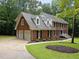 A spacious brick home with a two-car garage, well-kept landscaping, and a welcoming driveway and walkway at 221 Jansmith Ln, Raleigh, NC 27615