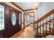 Elegant foyer featuring a wooden front door with decorative glass, hardwood floors, a staircase, and a chandelier at 221 Jansmith Ln, Raleigh, NC 27615