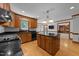 Traditional-style kitchen featuring oak cabinets, granite countertops, and a functional center island at 221 Jansmith Ln, Raleigh, NC 27615