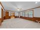 Bright living area featuring wainscoting, large windows, and easy access to the kitchen and outdoor spaces at 221 Jansmith Ln, Raleigh, NC 27615