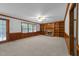 Spacious living room with a brick fireplace, built-in bookshelves, wainscoting, and neutral carpeting at 221 Jansmith Ln, Raleigh, NC 27615