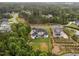 Aerial view of large house with spacious backyard, pond and neighboring houses at 2220 Inwood Landing Ct, Raleigh, NC 27603