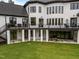 Two-story home featuring an outdoor patio area with covered seating, dining area, and a large well-manicured lawn at 2220 Inwood Landing Ct, Raleigh, NC 27603
