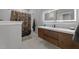 This modern bathroom boasts a wood vanity, white countertop, and a shower with a floral curtain at 2220 Inwood Landing Ct, Raleigh, NC 27603