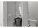 Modern powder room featuring a vessel sink, marble accent wall, and unique pendant mirror at 2220 Inwood Landing Ct, Raleigh, NC 27603