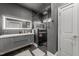 A modern bathroom with a glass shower, gray walls, and a dual vanity with LED mirrors at 2220 Inwood Landing Ct, Raleigh, NC 27603
