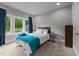 This is a cozy carpeted bedroom with blue and white decor and a large window at 2220 Inwood Landing Ct, Raleigh, NC 27603