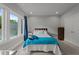 This is a cozy carpeted bedroom with blue and white decor and a large window at 2220 Inwood Landing Ct, Raleigh, NC 27603
