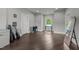 A gray bedroom with wood floors, a window, guitar and other furnishings at 2220 Inwood Landing Ct, Raleigh, NC 27603