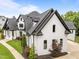 Striking aerial view of a white brick home with black trim and landscaping at 2220 Inwood Landing Ct, Raleigh, NC 27603