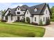 Beautiful white brick home with manicured lawn and professional landscaping at 2220 Inwood Landing Ct, Raleigh, NC 27603