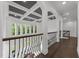 Bright hallway with coffered ceiling, dark hardwood floors, and black wrought iron railing at 2220 Inwood Landing Ct, Raleigh, NC 27603