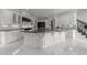 Elegant kitchen with marble floors, black countertops, state-of-the-art appliances, and custom cabinetry at 2220 Inwood Landing Ct, Raleigh, NC 27603