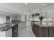 Spacious kitchen featuring marble floors, high-end appliances, custom island, and a butler's pantry at 2220 Inwood Landing Ct, Raleigh, NC 27603