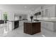 Modern kitchen features marble floors, custom cabinets, a large island, stainless steel appliances, and an open floor plan at 2220 Inwood Landing Ct, Raleigh, NC 27603