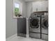 A laundry room with modern washer and dryer machines at 2220 Inwood Landing Ct, Raleigh, NC 27603