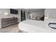 Comfortable main bedroom featuring a closet, a tv, bedside table, and a door to the backyard patio at 2220 Inwood Landing Ct, Raleigh, NC 27603