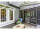 Relaxing back porch area with comfortable seating and views leading to a screened-in porch for outdoor enjoyment at 2325 Old Oak Pl, Hillsborough, NC 27278