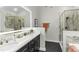 Modern bathroom with dual vanities, updated fixtures, a glass-enclosed shower, and updated lighting at 2325 Old Oak Pl, Hillsborough, NC 27278