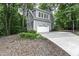 Charming gray home featuring an attached garage, well-manicured landscaping, and a basketball hoop at 2325 Old Oak Pl, Hillsborough, NC 27278