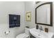 Updated half bathroom featuring an oval mirror, floating vanity, and coordinated towel rack at 2325 Old Oak Pl, Hillsborough, NC 27278